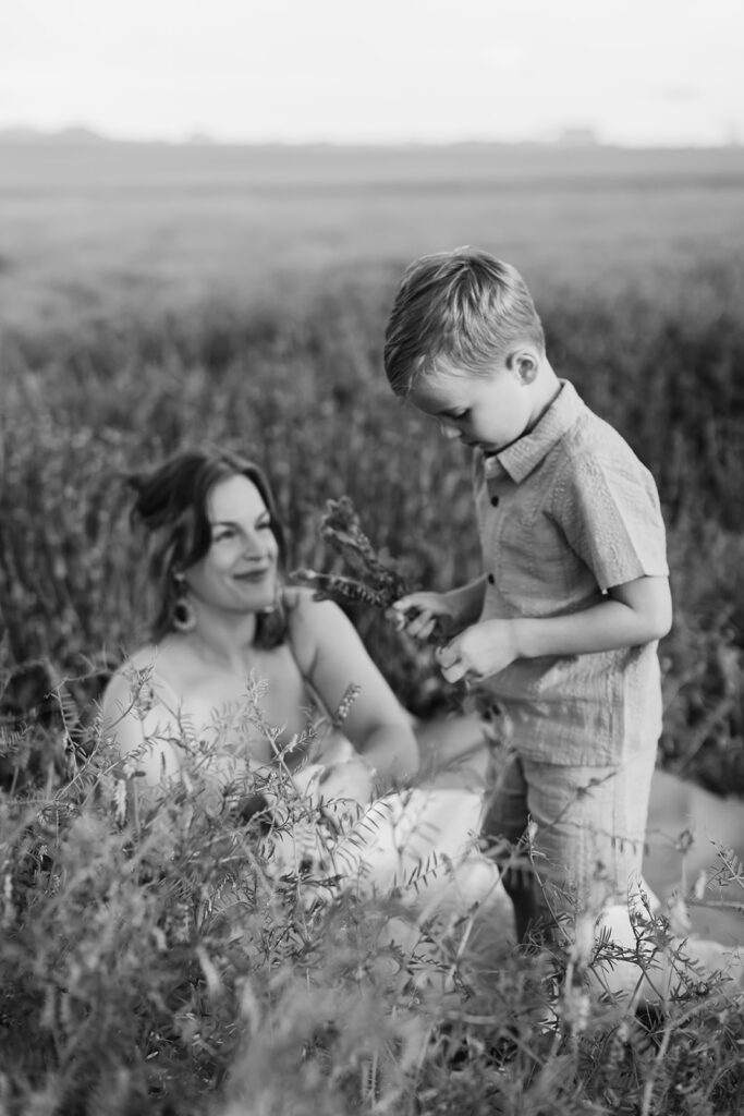mama and so. Outdoor photo session in green field.