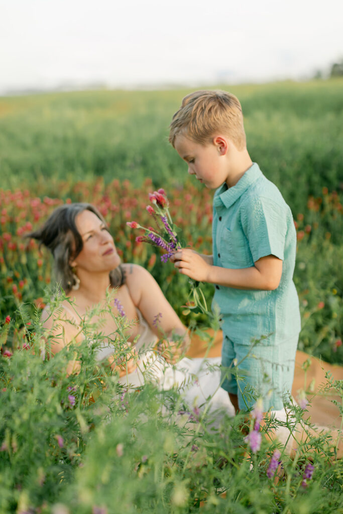 mama and so. Outdoor photo session in green field.