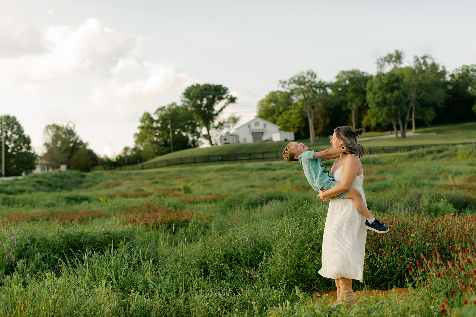 son and mama. Outdoor photo session in green field.